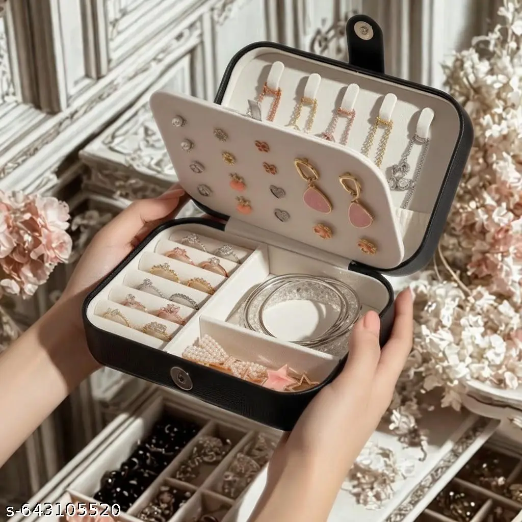 Black jewellery organiser open to reveal ring rolls, necklace hooks and an ivory interior